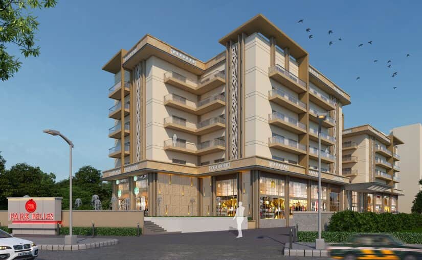 Park Belles apartment tower on Mussoorie Road, cream and brass facade with retail plinth at street level.